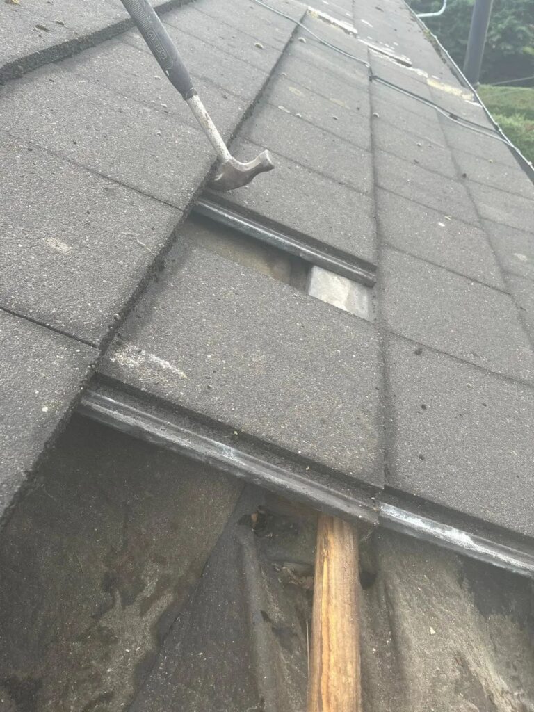 Slipped concrete tile with the batten and felt showing underneath